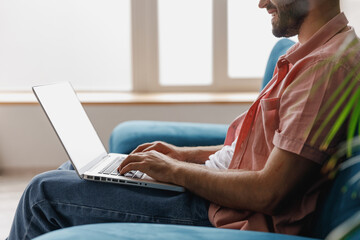 Wall Mural - cropped close up side view young smiling man in casual clothes hold use work on laptop pc computer l