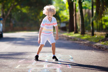Kids Play Hopscotch In Summer Park. Outdoor Game.