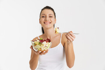 Wall Mural - European woman wearing underwear smiling while eating salad