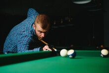Young Handsome Man Leaning Over The Table While Playing Snooker