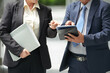 © DragonImages - Cropped image of successful business partners pointing at tablet computer when discussing details of contract