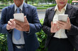© DragonImages - Positive business people reading notifications on smartphones or answering phone call from colleagues