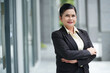 © DragonImages - Portrait of confident smiling senior female entrepreneur standing outdoors with arms crossed and looking at camera