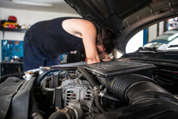 Mechanic at work on the car engine