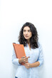 © Jake Jakab - Successful young caucasian businesswoman holding documents in office. Front view of smiling caucasian female freelancer working at home