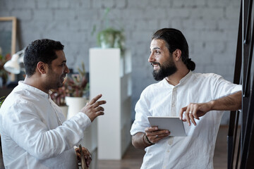 Wall Mural - Two confident businessmen discussing points of presentation or new project