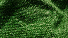 Close Up Yarn Olive Green Textile Fabric Background Showing Beautiful Wavy Or Crumpled Pattern. Wool Fabric Texture Close Up Background. Comfortable Style Cloth. Wavy Folds Material.