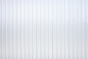 Striped wave silver steel metal sheet industry or construction site wall texture pattern for background.