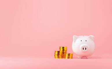 Money saving and investment concept. Piggy bank and coin stack on pink background with copy space