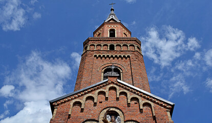 Wall Mural - A brick chapel and a Roman Catholic church of St. Michael the Archangel built at the turn of the 19th and 20th centuries in Jabłonka Kościelna in Podlasie, Poland.