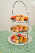 Three Tiers Of Plates Full Of Colorful French Macaron For Dessert
