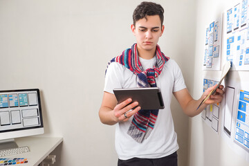 Wall Mural - application development for applications. young guy works as application developer. he is standing w