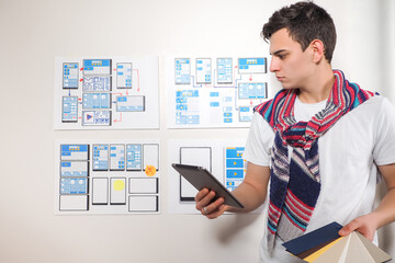 Wall Mural - manager in the application development studio. young guy works in a web studio. developer portrait n