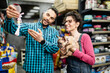 © hedgehog94 - Happy couple with their puppy buying toys and food in pet shop.
