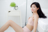 Fototapeta Na drzwi - Beautiful portrait young asian woman sexy in underwear figure fit relax with seductive in bedroom, asia girl body slim in lingerie confident and happy lying on bed in bedchamber, lifestyle concept.
