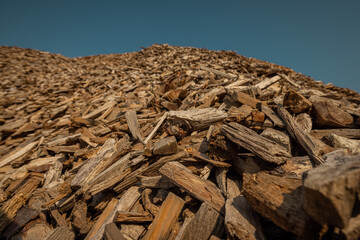 Forest residues mulched as wood chips used for heating. Pile of wood chip particles for biomass boiler, view from below.