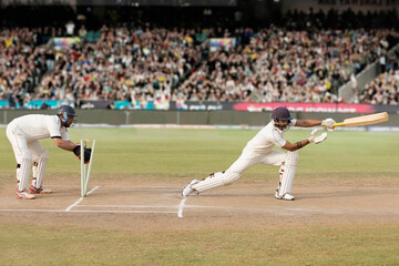 Batsman is Stumped by Wicket Keeper During a match in the stadium