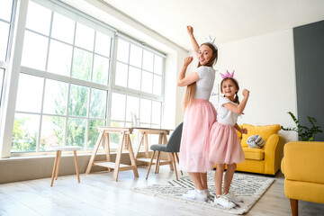 Canvas Print - Young woman and her little daughter dancing at home