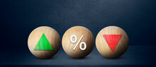 Interest Rate Financial Concept. Wooden Ball With Icon Green Arrow Up, Percentage And Red Arrow Down