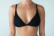 © blackday - Woman with natural breast wearing black swimwear top