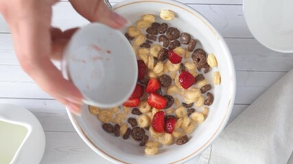 Wall Mural - Chocolate and corn flakes with milk are added chopped pieces of fresh strawberries. Concept of a healthy breakfast. Close up.