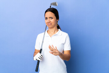 Young golfer woman over isolated colorful background nervous stretching hands to the front