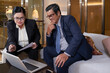 © DragonImages - Senior experienced head of marketing department showing presentation to company CFO at meeting