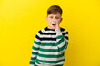 © luismolinero - Little redhead boy isolated on yellow background shouting with mouth wide open