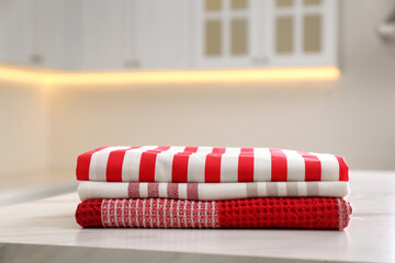 Sticker - Stack of soft kitchen towels on white table indoors