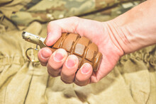 The Hand Grenade On Camouflage Background Close Up