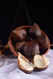 Fresh salak fruit on a dark background. Salacca zalacca, Salak fruit. A bunch of salak fruit in a fruit basket