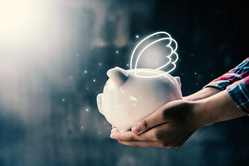 Woman hand holding white piggy bank to saving money concept.budget, financial.