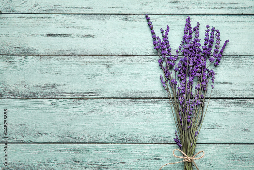 Beautiful lavender flowers on color wooden background