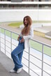 © Сергей Луговский - Young sensual fair-haired woman near metal railing at stadium