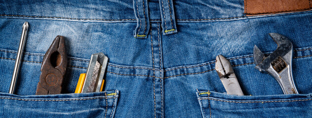 Top view design concept of Labor Day with working tools and jeans.