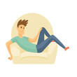 © the8monkey - Home leisure. Boy sit on sofa. Young people leisure time. Staying at home. Enjoyed leisure time alone