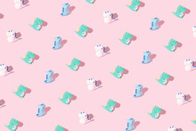 Trendy Colorful Pattern Made Of Dinosaurs On Pastel Pink Background. Toys For Kids.