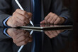 © NIKCOA - Business man in suit hand using electronic pen (stylus pencil, digitized pen) sign contract on digital tablet. e-document concept.