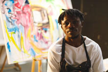 Portrait Of African American Male Painter At Work Looking At Camera In Art Studio
