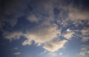 Wall Mural - starry sky and long exposhur clouds. dark night sky with clouds. astronomical background.