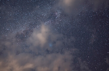 Wall Mural - starry sky and long exposhur clouds. dark night sky with clouds. astronomical background.
