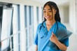 © Serhii - portrait of friendly, smiling confident female healthcare professional with lab coat, arms crossed holding glasses. Isolated hospital clinic background.
