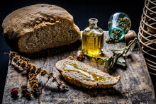 High Angle View Of Olive Oil And Organic Bread On Table
