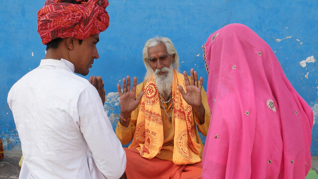 Religious ascetic Sadhu blessing young newlyweds