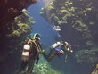 scuba diver takes pictures underwater