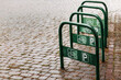 Bicycle parking on the pavement. Green metal construction for bicycle parking