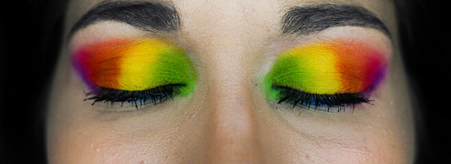 eye-catching vivid makeup eye details of a young girl. homosexual flag makeup