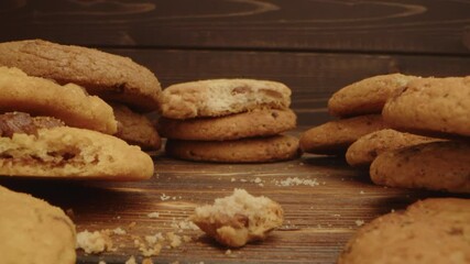 Wall Mural - Macro zoom in video of crispy oat cookies on wooden board in kitchen