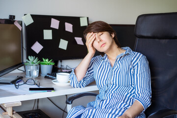 Feeling tired. Frustrated businesswoman taking a break during online work on pc. Suffering from headache, exhausted worker sitting with eyes closed, relieving pain and calming down. Overwork concept.