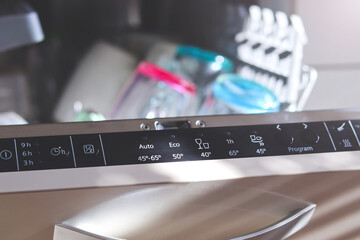 Open dishwasher with clean dishes after washing